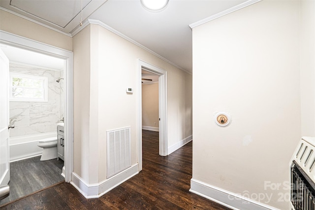 hallway with dark hardwood / wood-style floors, heating unit, and ornamental molding