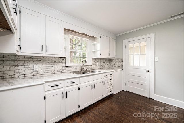 kitchen with tasteful backsplash, dark hardwood / wood-style flooring, sink, and white cabinets