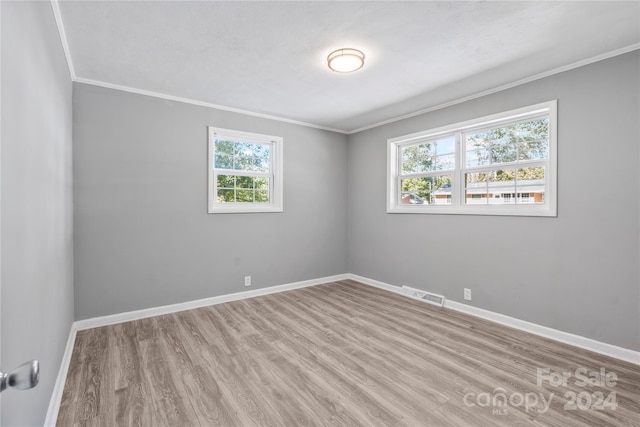 spare room with light hardwood / wood-style floors and ornamental molding