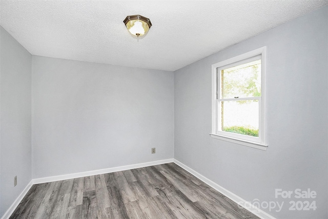 1613 Ohenry Ln, Fort Mill, SC 29708 - empty room featuring dark wood finished floors and a textured ceiling