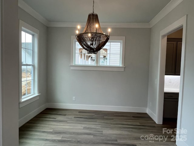 unfurnished dining area featuring ornamental molding, a chandelier, and light hardwood / wood-style floors