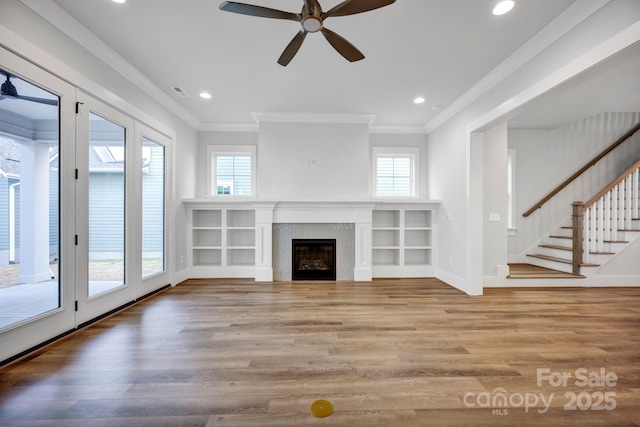 unfurnished living room with crown molding, ceiling fan, and wood-type flooring