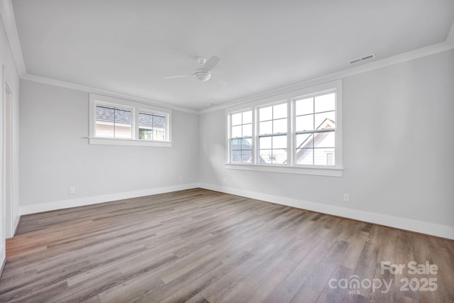 spare room featuring crown molding, light hardwood / wood-style floors, and ceiling fan