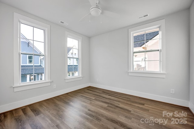 unfurnished room with dark hardwood / wood-style floors and ceiling fan