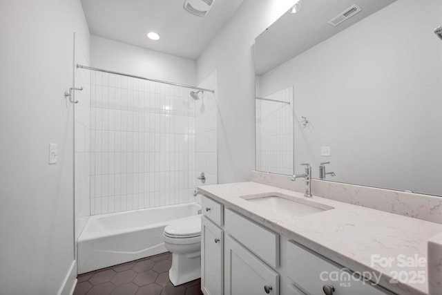 full bathroom with tile patterned floors, vanity, toilet, and tiled shower / bath combo