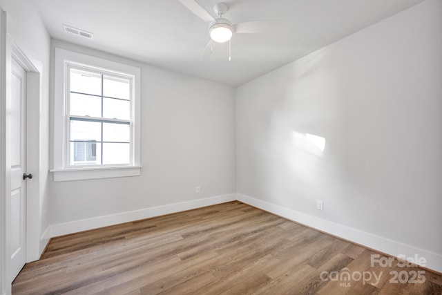 empty room featuring ceiling fan and light wood-type flooring