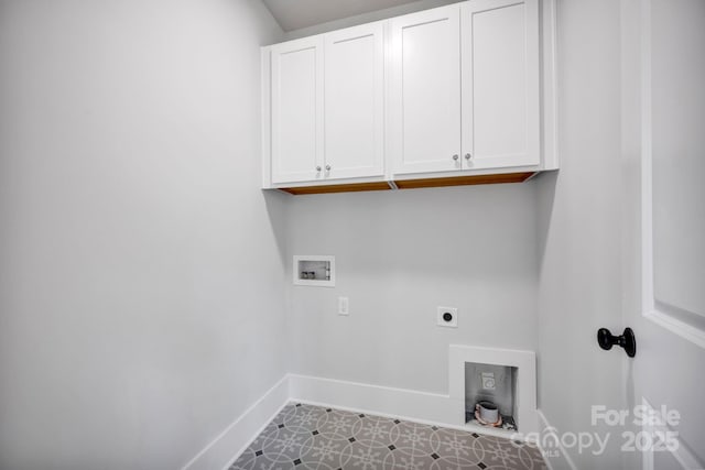 clothes washing area with cabinets, electric dryer hookup, and washer hookup