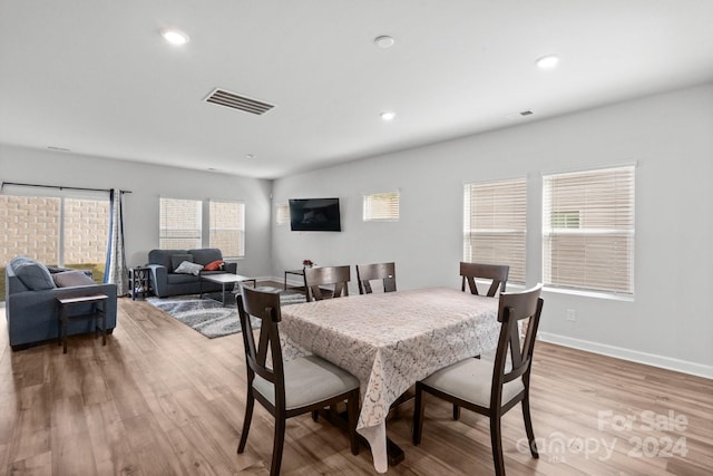 dining space with light hardwood / wood-style flooring