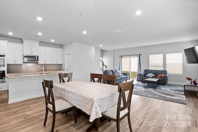 dining space featuring light hardwood / wood-style flooring