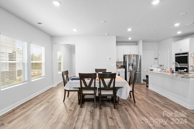 dining area with light hardwood / wood-style floors