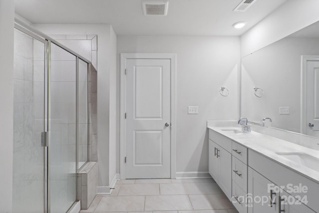 bathroom with vanity, tile patterned floors, and a shower with shower door