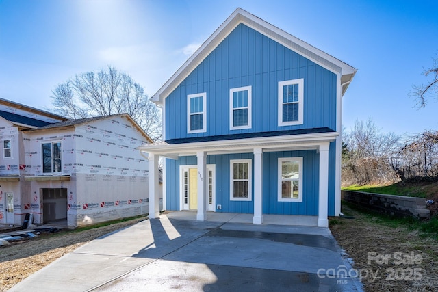 view of front property featuring covered porch and a garage