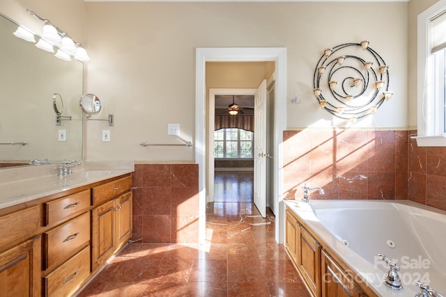 bathroom featuring vanity, tile walls, a washtub, and ceiling fan