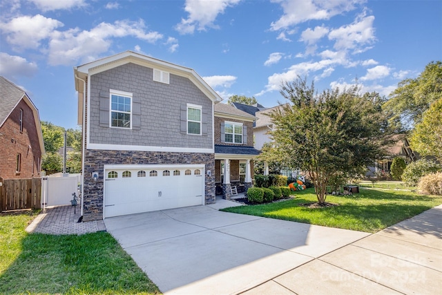 view of front of house featuring a front lawn and a garage