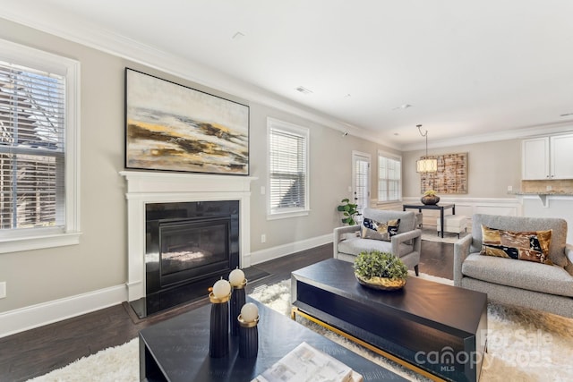 living room featuring dark hardwood / wood-style flooring and ornamental molding