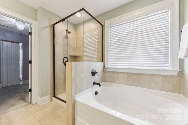 bathroom featuring tile patterned floors and independent shower and bath