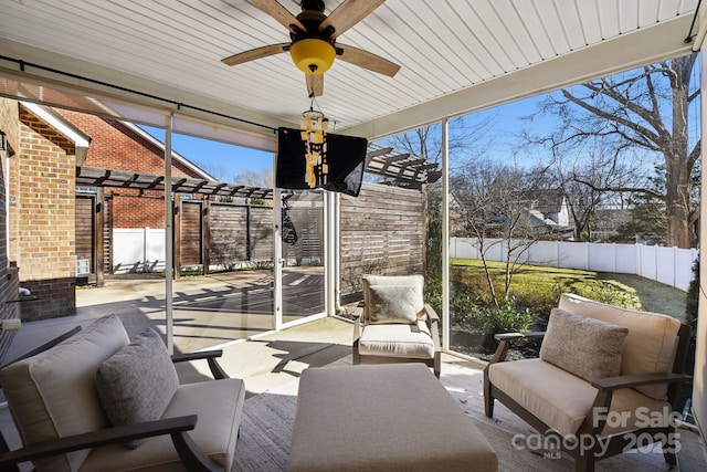 sunroom / solarium featuring ceiling fan