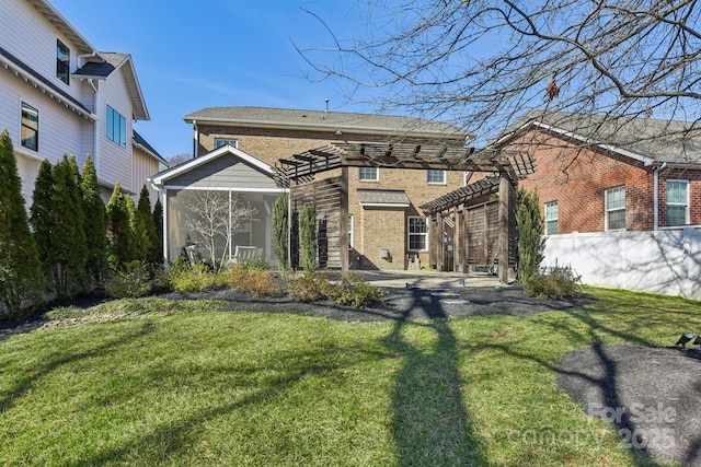 back of property featuring a pergola and a lawn