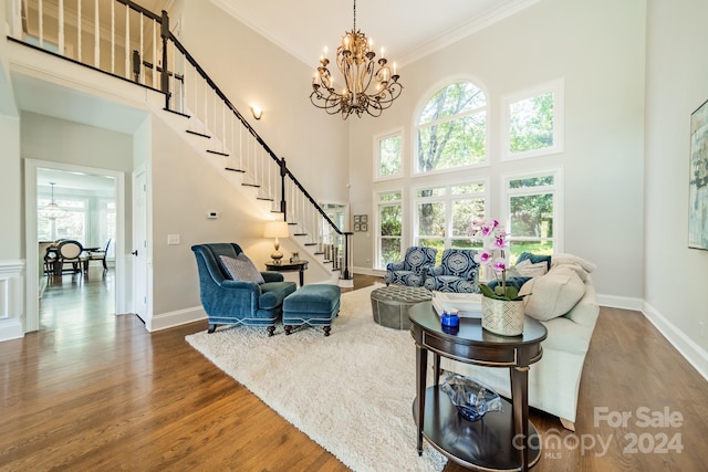 living room featuring a healthy amount of sunlight, crown molding, dark hardwood / wood-style floors, and a towering ceiling