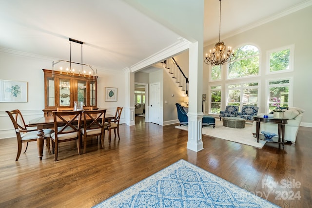 dining area with crown molding, dark wood-type flooring, and a high ceiling