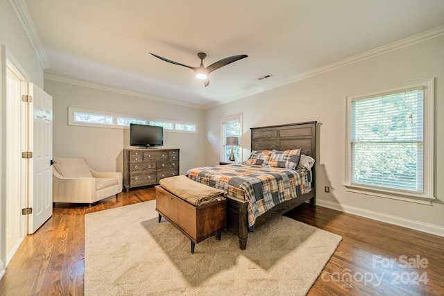 bedroom with hardwood / wood-style floors, crown molding, multiple windows, and ceiling fan