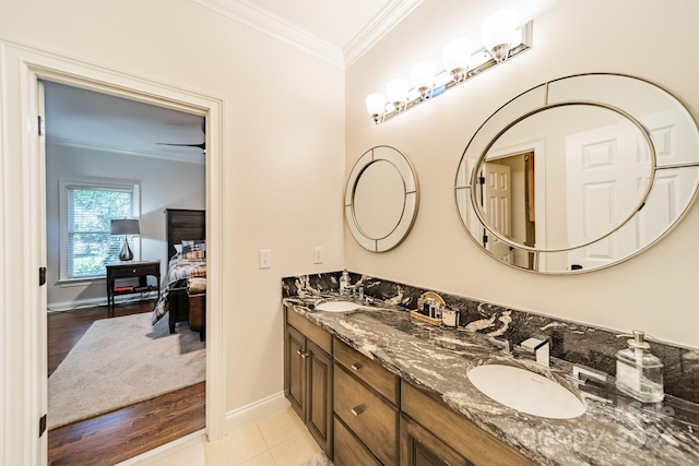 bathroom with vanity, crown molding, and hardwood / wood-style floors