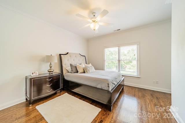 bedroom with crown molding, dark wood-type flooring, and ceiling fan