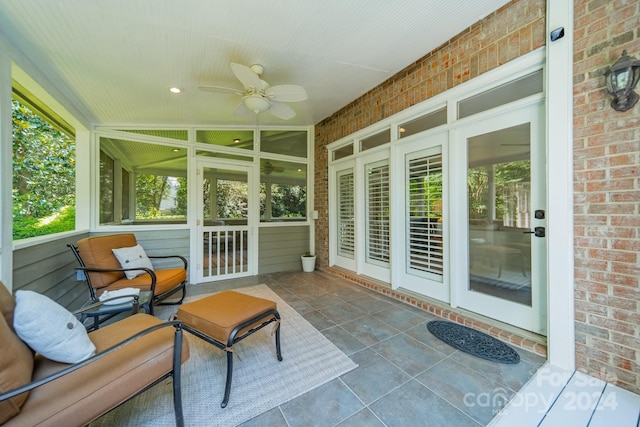 sunroom with ceiling fan and vaulted ceiling