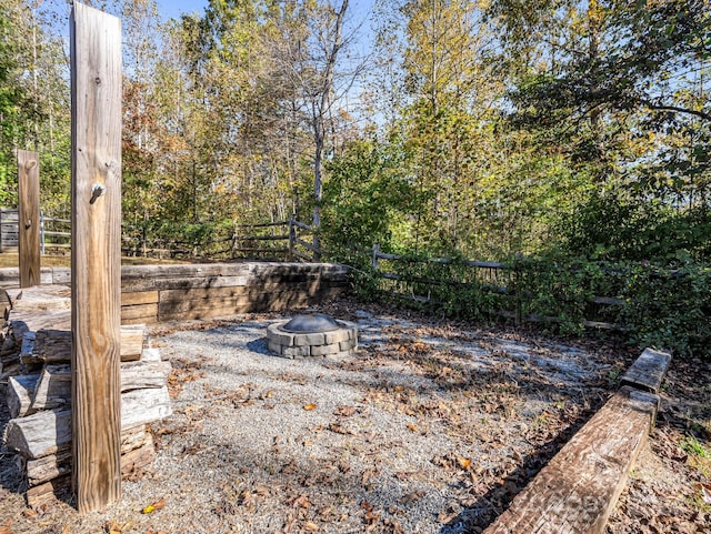 view of yard with a fire pit