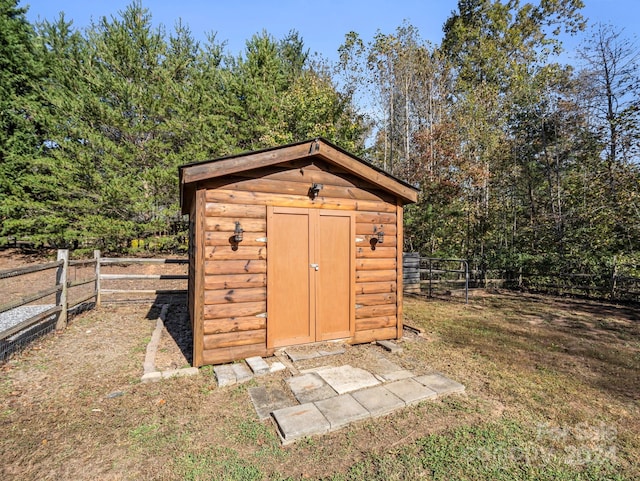 view of outbuilding featuring a lawn