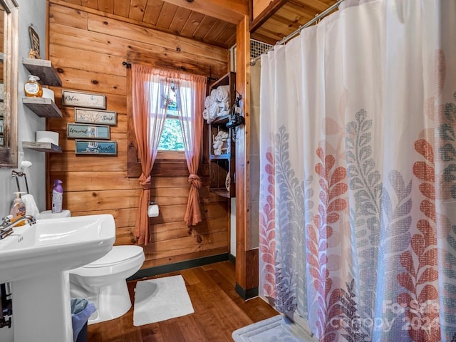 bathroom featuring wood walls, a shower with shower curtain, hardwood / wood-style floors, toilet, and wooden ceiling