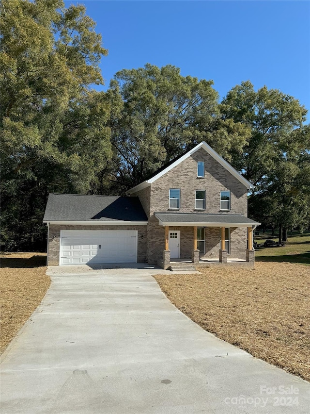 view of front of property with a garage and a porch