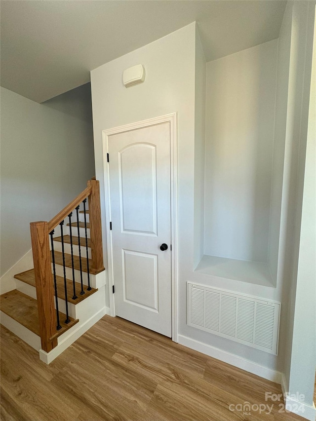 staircase featuring hardwood / wood-style flooring