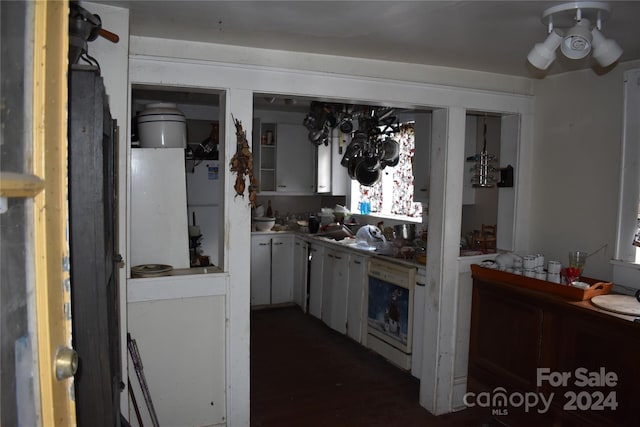 kitchen featuring white cabinetry and sink