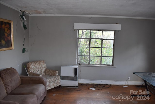 unfurnished room with dark wood-type flooring, heating unit, and ornamental molding