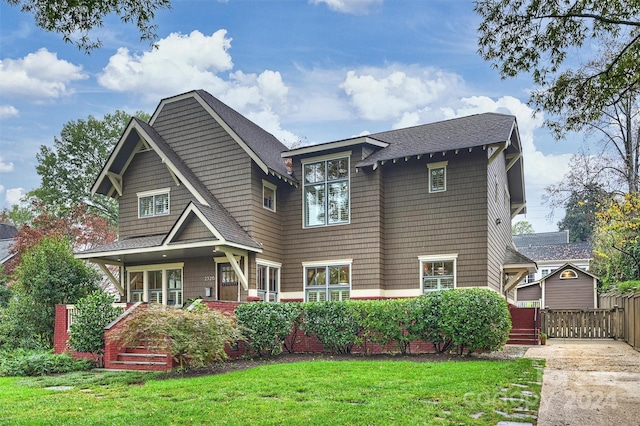 rear view of property featuring a yard