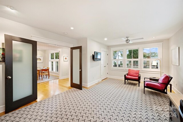 sitting room featuring light hardwood / wood-style floors and ceiling fan