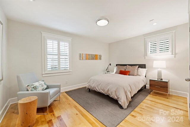 bedroom with hardwood / wood-style flooring