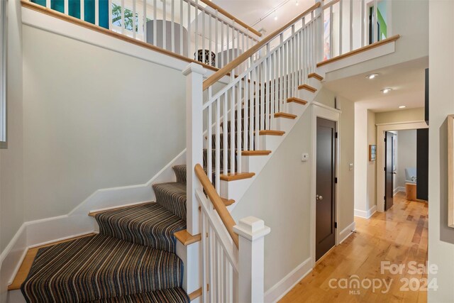 staircase with hardwood / wood-style flooring