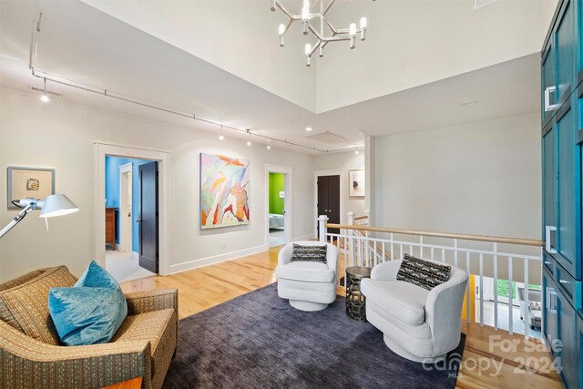 interior space with hardwood / wood-style floors and an inviting chandelier