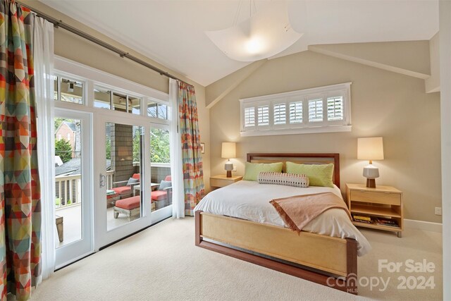 carpeted bedroom featuring access to outside and vaulted ceiling