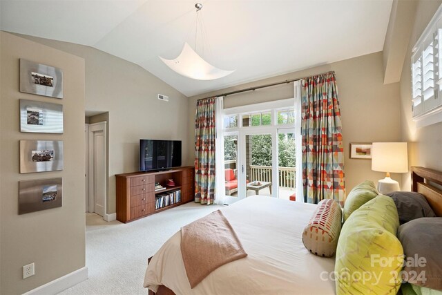 bedroom with access to outside, lofted ceiling, and light carpet