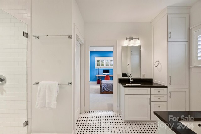 bathroom featuring walk in shower and vanity