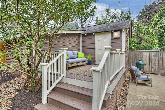 wooden deck with an outdoor structure