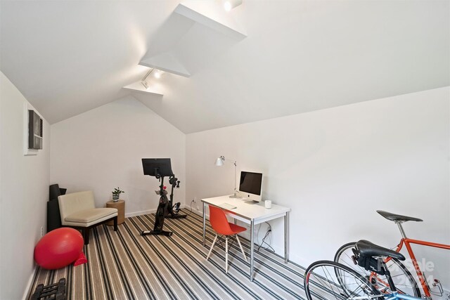 office space featuring light carpet, track lighting, and lofted ceiling