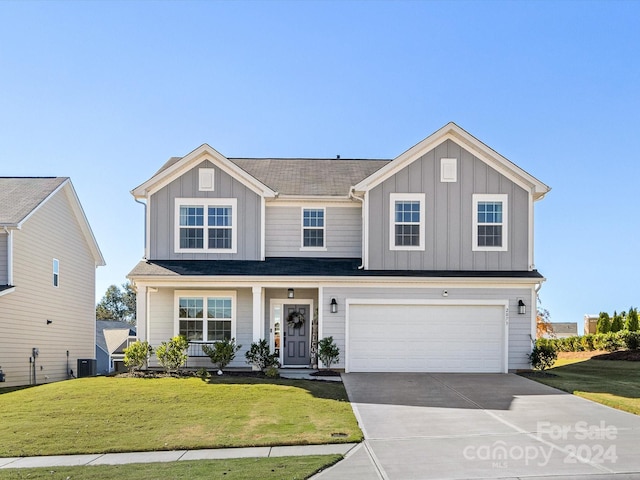 view of front facade featuring a front yard, a porch, and a garage