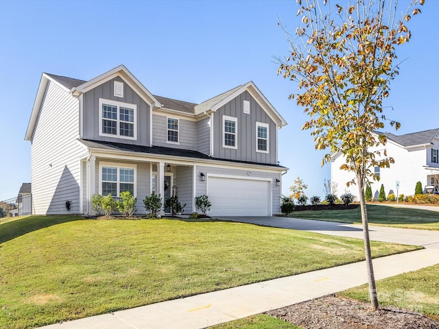 view of front of property with a front yard and a garage