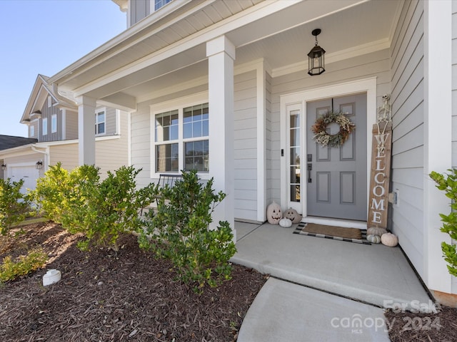 property entrance featuring a porch and a garage