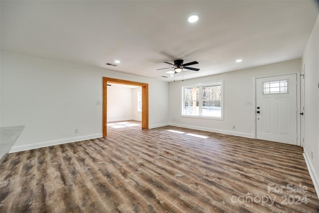 unfurnished living room featuring ceiling fan and wood-type flooring