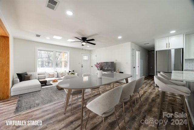 dining area featuring ceiling fan and dark wood-type flooring